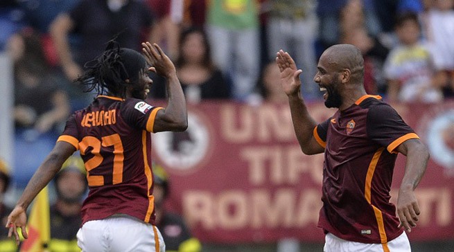 Roma's forward from Ivory Coast Gervinho (L) celebrates with his team mate Roma's defender from Brazil Maicon after scoring during the Italian Serie A football match AS Roma vs Carpi on September 26, 2015 at Rome's Olympic stadium. AFP PHOTO / ANDREAS SOLARO (Photo credit should read ANDREAS SOLARO/AFP/Getty Images)
